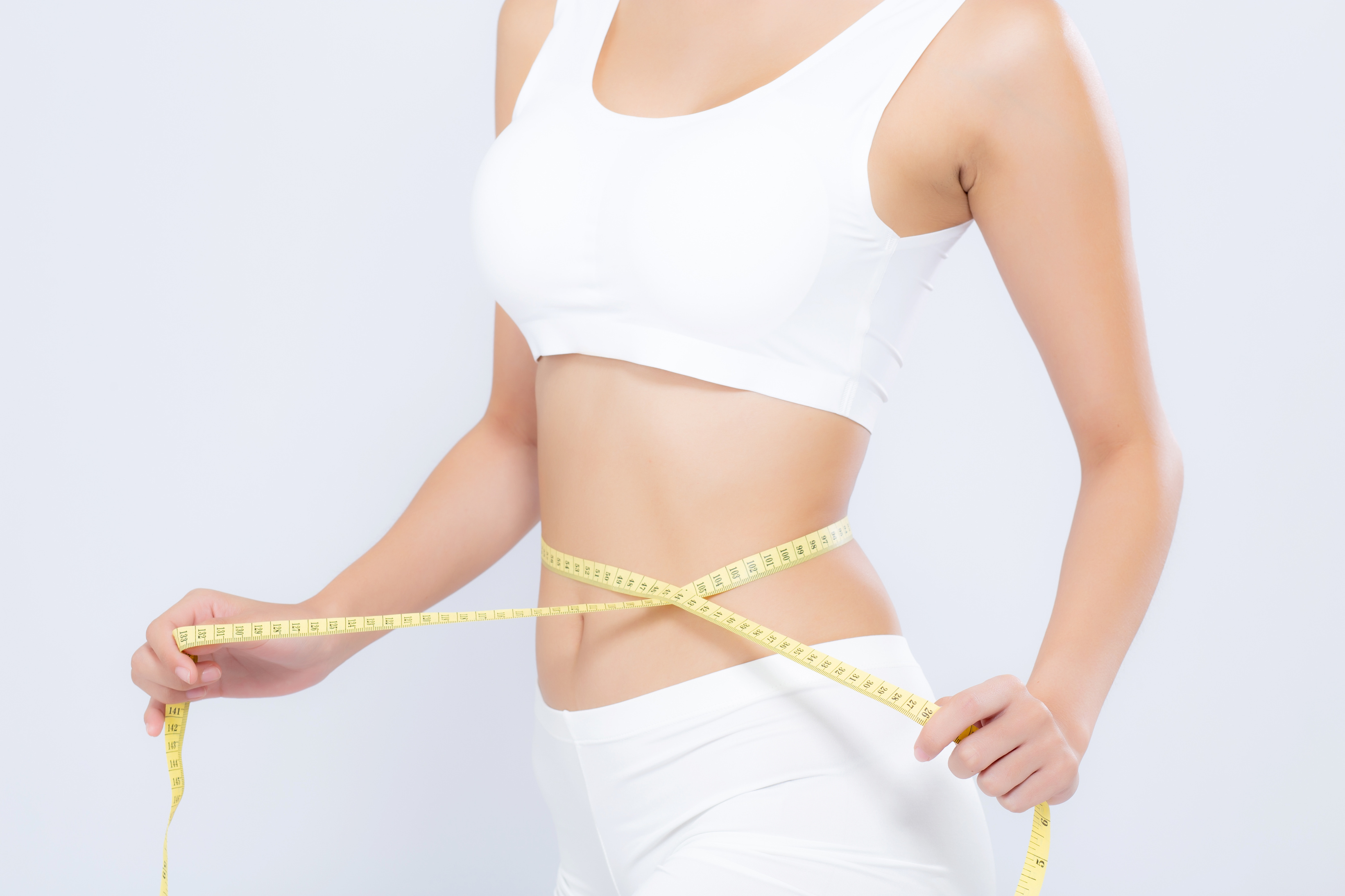 Woman Measuring Waist with Tape Measure